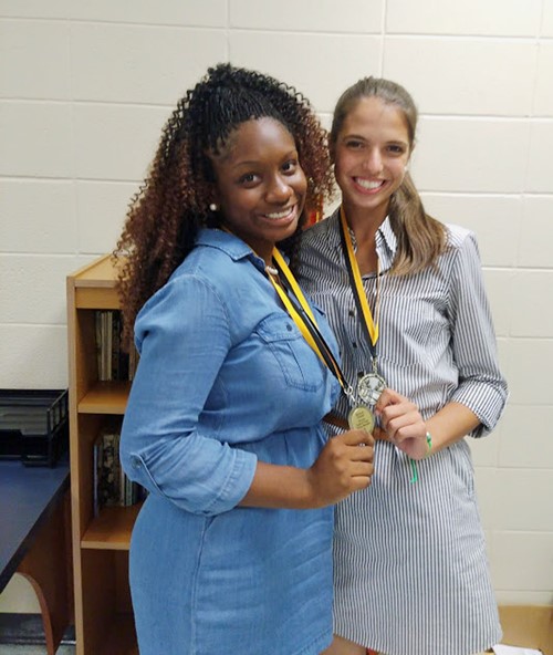 TCCHS Debate members Taylor Smith and Kennedy Ward show off their medals earned during the Oct. 15 Wildcat Classic.