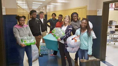 TCCHS students Charadi Paytee, Dondre Daniels, Blake Kirkendoll, Sanny Patel, Arina Warren, Leigh Barwick (teacher), Ilyria Johns, and Eurica Bush pause for the camera with some of the donated items.