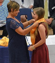 Senior Katie Warren receives her honor graduate stole from TCCHS Principal Trista Jones.