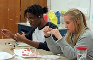 TCCHS ceramics students Malik Staples and Kimberly Cain work during class.