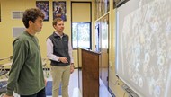  TCCHS AP Art History teacher Brett James and student Riley Jones discuss a slide.