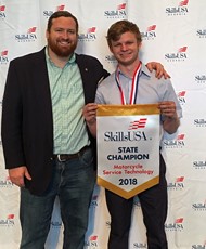 TCCHS student Stanley Clay (right) and instructor Michael Clapper after Clay’s first place win in Motorcycle Service Technology during the recent Georgia SkillsUSA Leadership and Skills Conference.