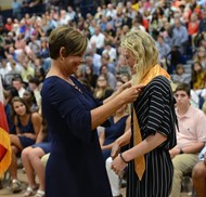 Cara Eaton is given her honor graduate stole from Principal Trista Jones.