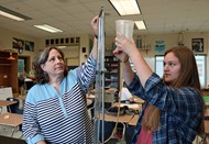 AP Physics student Hailey Ferrel and instructor Laura Kornegay use a tuning fork and a resonance tube to determine the speed of sound.