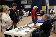 A representative of CNS Machine Company, Nelson Caviness, interacts with TCCHS students Aubri Johnson and Aaron Brock.