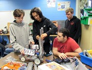 Colby Thomas, Hiram Henry, Nathan Gibson and Jacob Brinson work on the design and assembly of a vertical lift system.