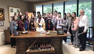 TCCHS Chick-fil-A Leader Academy members pose for a photo inside restaurant founder S. Truett Cathy’s office.