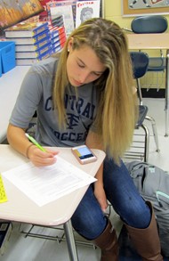 Student Langley Wooten calculates her score for a political party activity conducted in the AP Government class she shadowed.