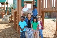 On the playground is Dee Gaines (center) surrounded by kindergarten students Xalen James, from left, Sam Stewart, Destiny Hobbs, Rosie Cooper, and Blake Knisely.