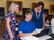 Instructional Technology Specialist Lindsay Thompson and TCCHS Principal Trista Jones observe Jackson Groom working on a Chromebook in Ryan Strickland's Physics classroom. 