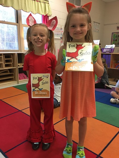 Moms read Dr. Seuss books to students.