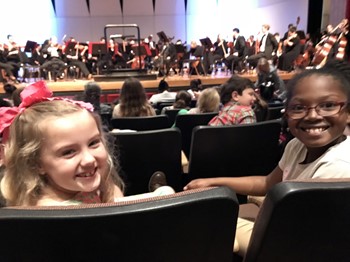 Adeline Finch, left, and Elizabeth Burgess show their excitement before the Valdosta Symphony performs.